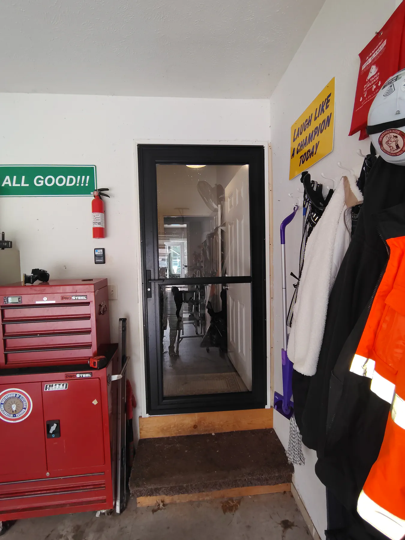 Installed black storm door viewed from inside a garage