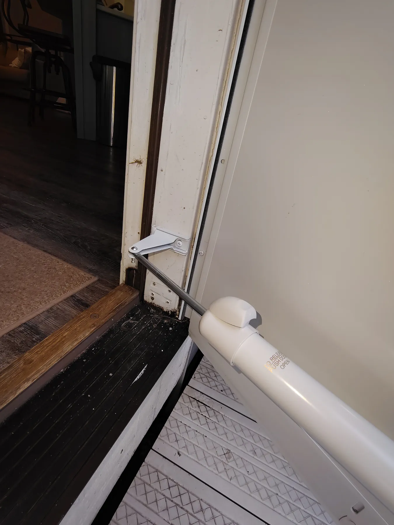 Storm door closer hardware secured to the entry frame