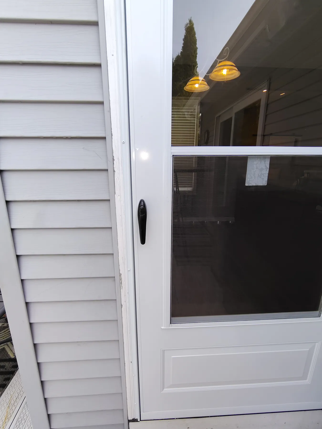 Close view of the finished white storm door and handle