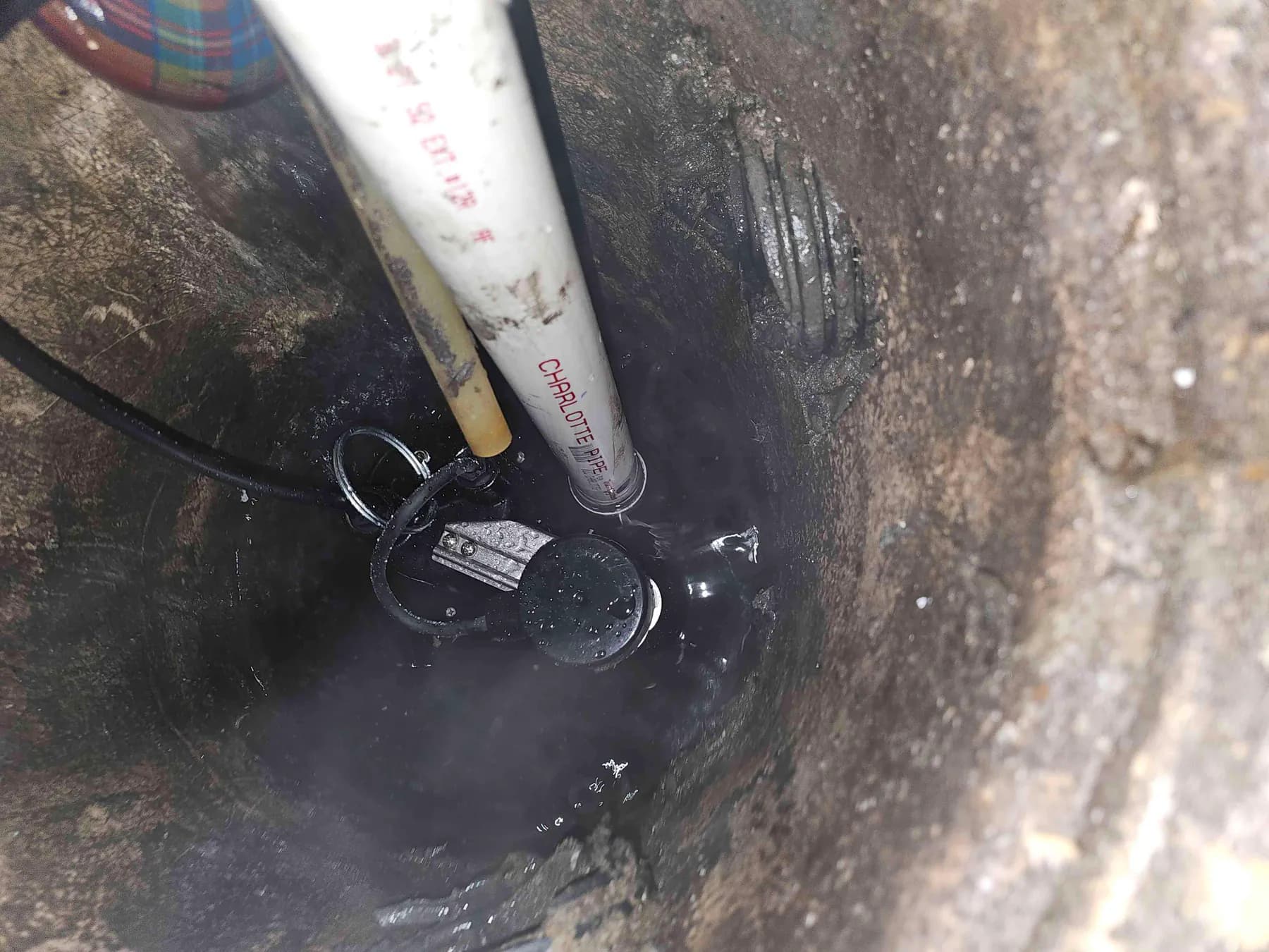Sump pump and discharge pipe inside the basin
