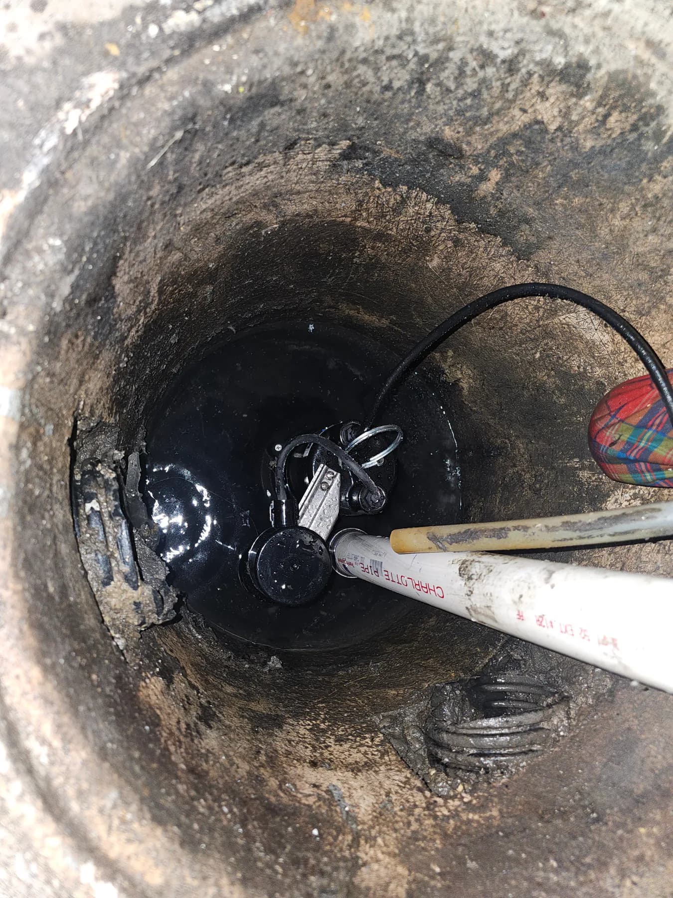 Wide view into the sump basin after pump installation