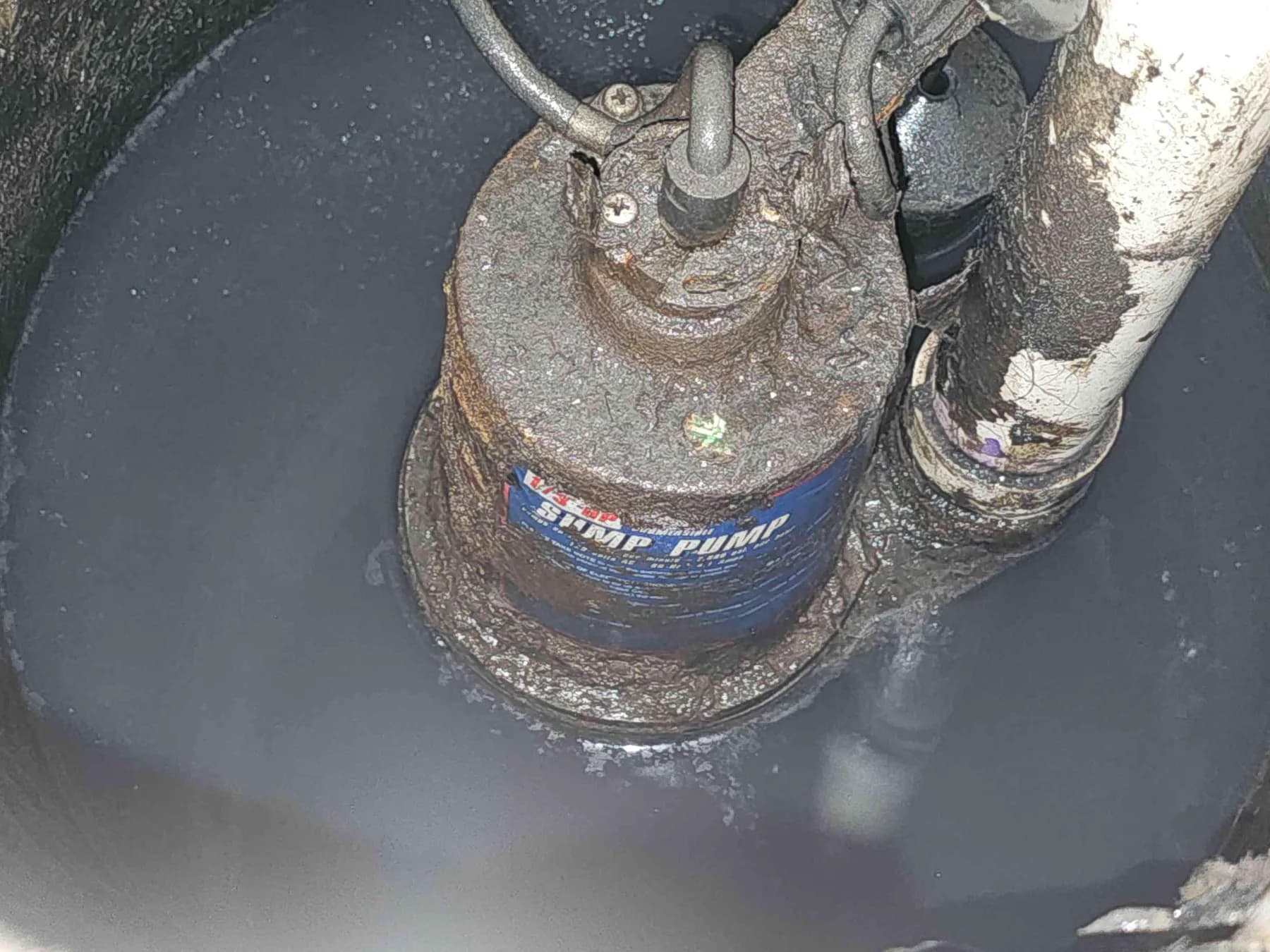 Existing corroded sump pump before replacement
