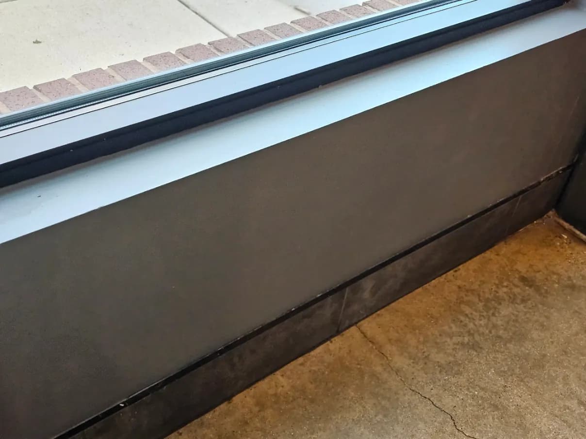 Repaired window sill and wall with a clean finished surface
