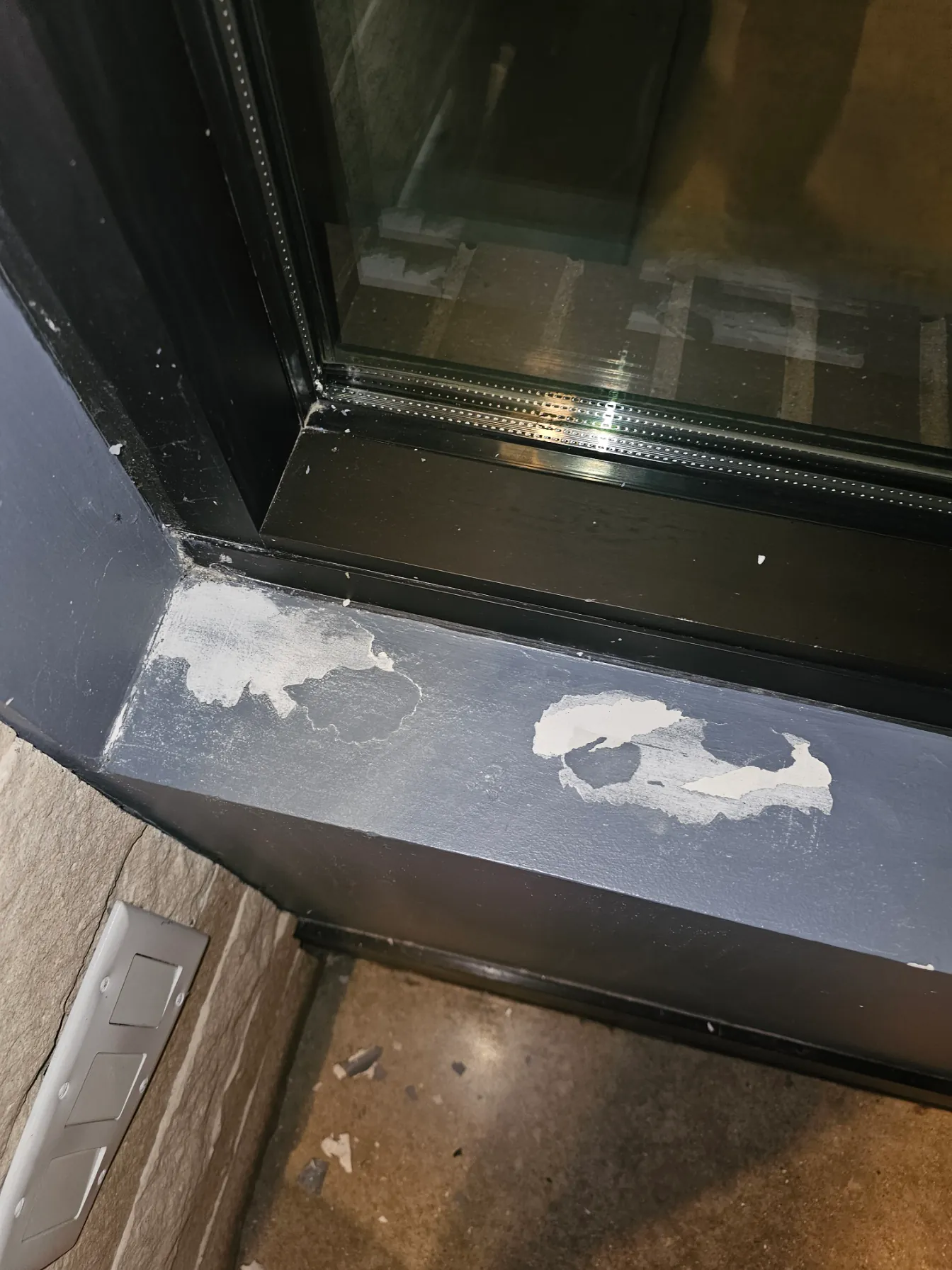 Damaged window sill and peeling finish before repair